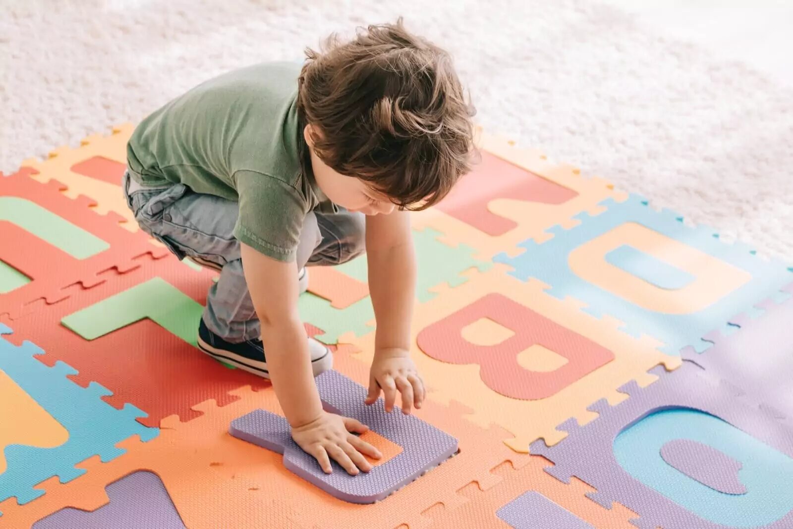 Child plays with large puzzle pieces made of EVA foam material