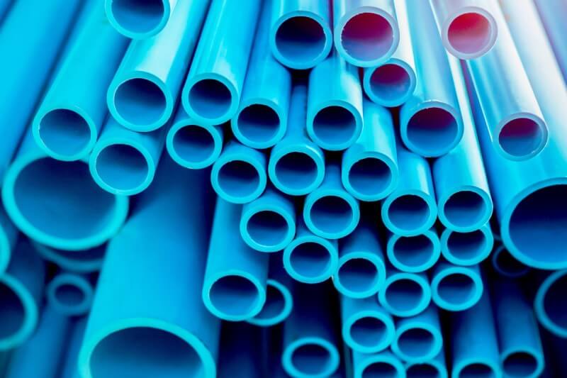 A stack of blue PVC pipes.