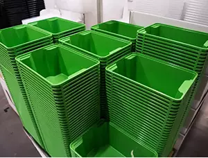 Stacked green plastic bins